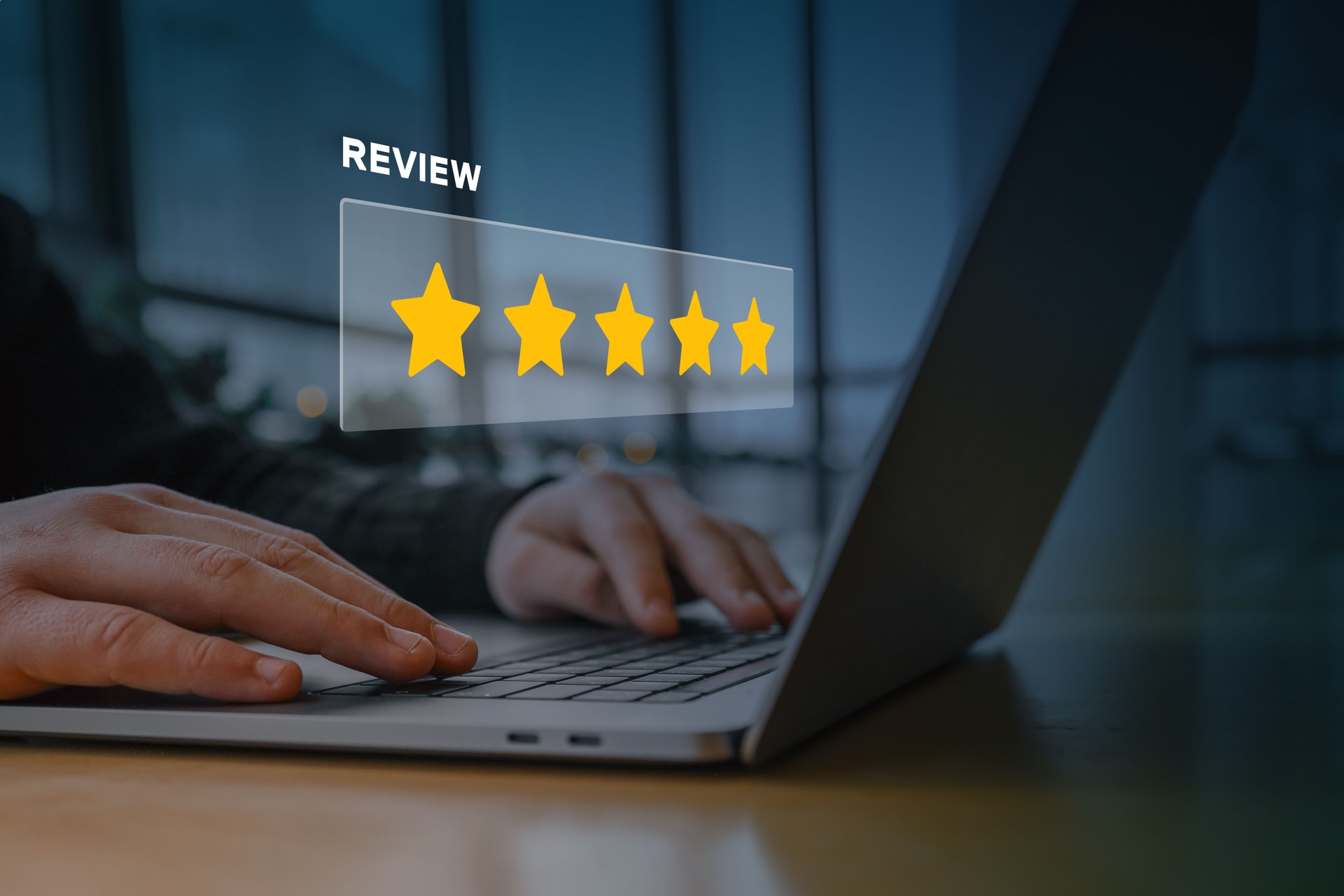 A person using a laptop with a digital overlay of a five-star rating and the word "review." Concept of customer feedback, online reputation, business rating, and digital marketing strategy